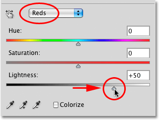 Dragging the Lightness slider in the Hue/Saturation dialog box in Photoshop. Image © 2010 Photoshop Essentials.com